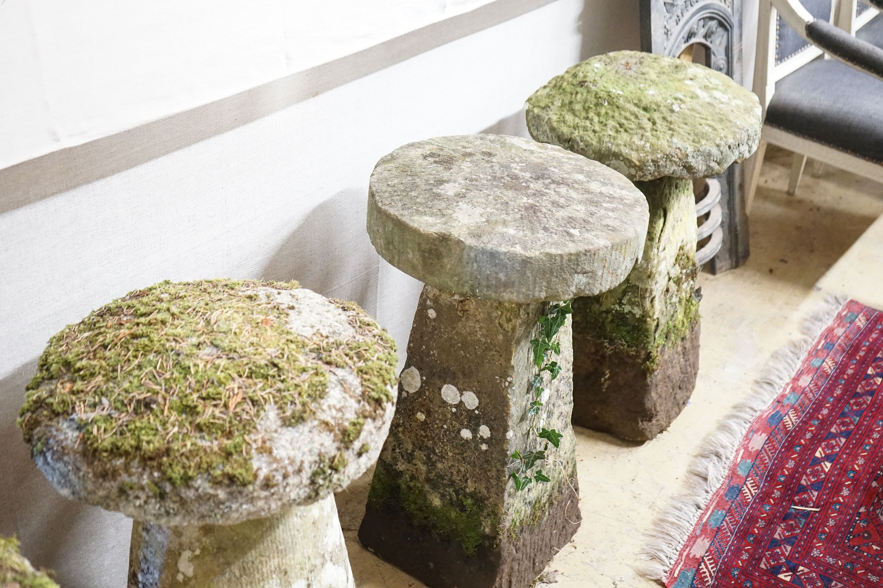 Four weathered staddle stones, largest width 44cm, height 74cm